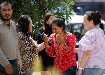 A woman reacts outside the Ssgt Willie de Leon Civic Center, where students had been transported from Robb Elementary School after a shooting, in Uvalde, Texas, U.S. May 24, 2022.  REUTERS/Marco Bello
