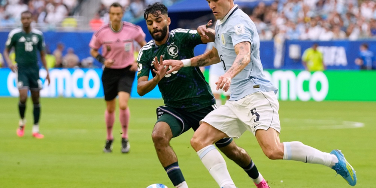 Uruguay's Manuel Ugarte, right, and Saudi Arabia's Mohammed Abu Alshamat battle for the ball during a World Cup Group H soccer match in Miami Gardens, Fla., Monday, June 15, 2026. (AP Photo/Lynne Sladky)
